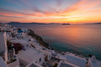 Mykonos with cruise at the horizon with sunset colours, but can still can see blue of the sea